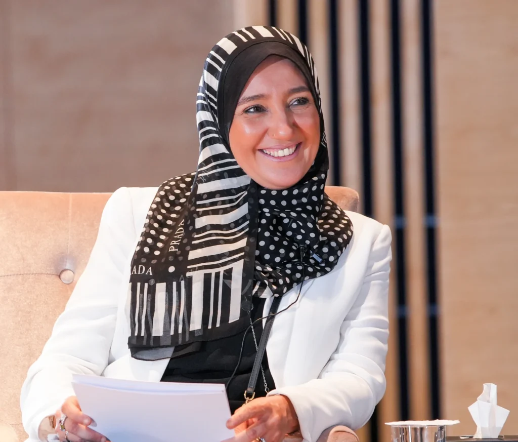 Person smiling and holding papers