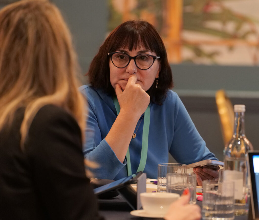 Top Management Programme delegates speaking around a table