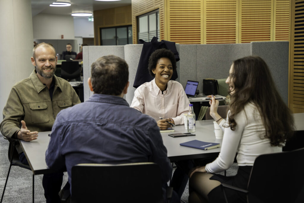 A group of colleagues chatting around a table
