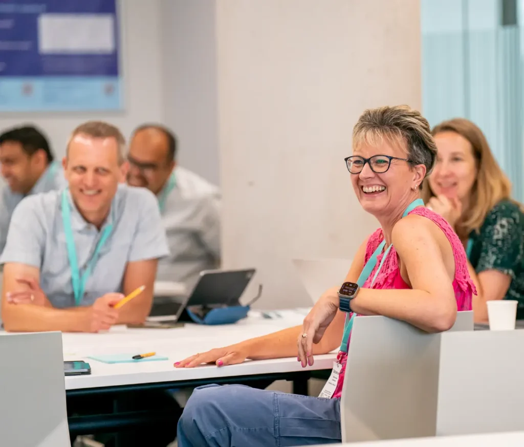 A smiling group of people sat around a table