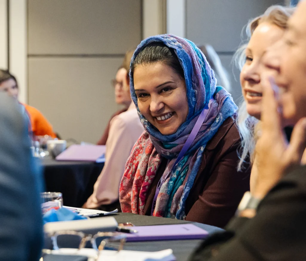 Person at a conference smiling