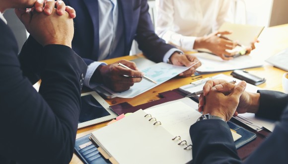 Leaders in a discussion around a table