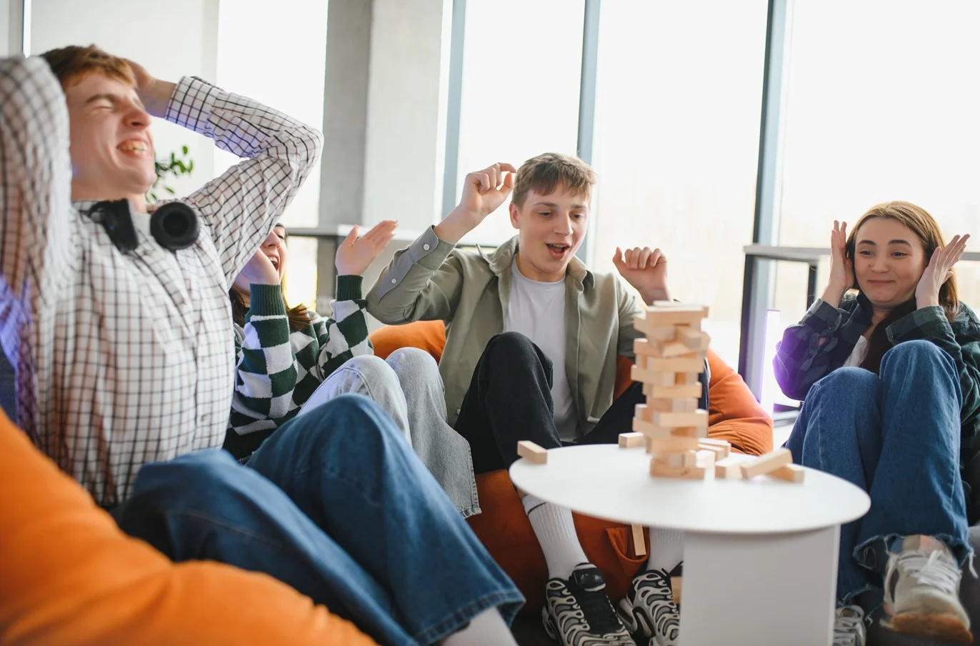 Excited friends playing skill game and having fun together